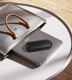 SGG VAULT Charge compact lifestyle carry photo on a laptop and bag setup — SmartGlass Gear