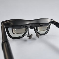 SGG BREEZE six-slot bracket installed inside XREAL One Pro glasses: three rectangular openings per end, six total. Glasses and insert frame shown for installation context.